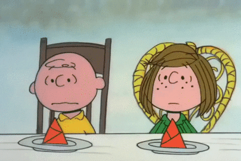 Charlie Brown and his friends are at a table eating pumpkin pie. Peppermint Patty is talking to Charlie Brown.